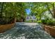 Long driveway leading to an attractive home with mature trees and a brick fence, offering privacy at 468 W Paces Ferry Rd, Atlanta, GA 30305