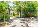 Gated entrance to a beautiful home, featuring a stone wall, lush landscaping, and a well-manicured lawn at 468 W Paces Ferry Rd, Atlanta, GA 30305