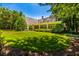 A sprawling lawn, mature trees and a covered front porch highlight the beauty of this home's exterior at 468 W Paces Ferry Rd, Atlanta, GA 30305