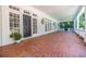 Inviting covered front porch showcasing brick flooring, white trim, sconces, and a welcoming entryway at 468 W Paces Ferry Rd, Atlanta, GA 30305