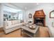 Open-concept living room with hardwood floors, fireplace, neutral decor and a view into the dining room at 468 W Paces Ferry Rd, Atlanta, GA 30305