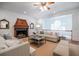 Bright living room with fireplace, hardwood floors, neutral decor, and views of the staircase and front yard at 468 W Paces Ferry Rd, Atlanta, GA 30305