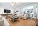 Spacious living room with hardwood floors, fireplace, decorative columns, and a view into the dining room at 468 W Paces Ferry Rd, Atlanta, GA 30305