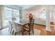 Bright living room with decorative fireplace, hardwood floors, large windows, and a view into the dining room at 468 W Paces Ferry Rd, Atlanta, GA 30305