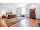 Spacious primary bedroom featuring hardwood floors and a large arched window with natural light at 468 W Paces Ferry Rd, Atlanta, GA 30305