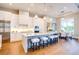 Modern kitchen with white cabinetry, marble countertops, an island with seating, and stainless steel appliances at 0 Ebenezer Rd, Fayetteville, GA 30215