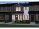 Charming townhome featuring a covered entrance, modern siding, and professionally landscaped front yard at 2266 Ashton Dr, Conyers, GA 30013