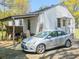 Back of house and a silver car sitting on concrete at 2453 Fernleaf Ln, Decatur, GA 30033