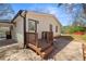 The back of the house features a small deck with stairwell access and an outdoor light fixture at 2740 Flagstone Se Dr, Atlanta, GA 30316