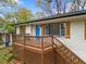 A gorgeous home with a bright blue front door and a wooden porch with lattice at 2740 Flagstone Se Dr, Atlanta, GA 30316