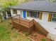 Beautiful home featuring a wooden porch with lattice and brickwork and a bright blue door at 2740 Flagstone Se Dr, Atlanta, GA 30316