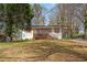 Charming, renovated home with a bright blue front door, shutters, and a covered carport at 2740 Flagstone Se Dr, Atlanta, GA 30316