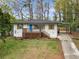 Charming, renovated home with a bright blue front door, shutters, and a covered carport at 2740 Flagstone Se Dr, Atlanta, GA 30316