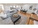 Open-concept living room and dining area featuring a comfortable gray sofa and stylish decor at 2740 Flagstone Se Dr, Atlanta, GA 30316