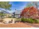 Large backyard with a patio, fire pit, manicured lawn, and mature trees at 5848 Deer Crossing Dr, Sugar Hill, GA 30518