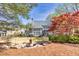 Spacious backyard featuring a lush lawn, mature trees, and inviting outdoor living areas at 5848 Deer Crossing Dr, Sugar Hill, GA 30518