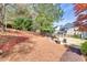 Spacious backyard with lush landscaping, patio and fire pit at 5848 Deer Crossing Dr, Sugar Hill, GA 30518