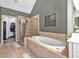 Bathroom featuring tiled floors, a tub, a shower and white cabinetry at 5848 Deer Crossing Dr, Sugar Hill, GA 30518