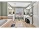 Bathroom featuring tiled floors, a tub, double vanities and white cabinetry at 5848 Deer Crossing Dr, Sugar Hill, GA 30518