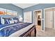 Relaxing bedroom featuring a doorway to the ensuite bathroom and a comfy bed at 5848 Deer Crossing Dr, Sugar Hill, GA 30518