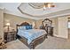 Spacious primary bedroom featuring decorative tray ceilings and a stately bedroom set at 5848 Deer Crossing Dr, Sugar Hill, GA 30518