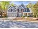 Charming brick and siding two-story home featuring a spacious two-car garage and well-manicured front lawn at 5848 Deer Crossing Dr, Sugar Hill, GA 30518