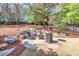Outdoor fire pit area with stone seating and a portable heater for cozy evenings at 5848 Deer Crossing Dr, Sugar Hill, GA 30518