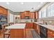 Gourmet kitchen with custom cabinetry, black appliances and island seating at 5848 Deer Crossing Dr, Sugar Hill, GA 30518