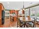 Eat-in kitchen features custom cabinets, hardwood floors, and bright window views at 5848 Deer Crossing Dr, Sugar Hill, GA 30518