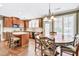 Eat-in kitchen features custom cabinets, hardwood floors, and bright window views at 5848 Deer Crossing Dr, Sugar Hill, GA 30518