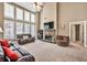 Spacious living room featuring a stone fireplace, large windows, and comfortable seating at 5848 Deer Crossing Dr, Sugar Hill, GA 30518