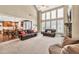 Bright living room with high ceilings, large windows, and open layout to the kitchen and dining area at 5848 Deer Crossing Dr, Sugar Hill, GA 30518
