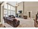 Inviting living room with fireplace, vaulted ceilings, and large windows at 5848 Deer Crossing Dr, Sugar Hill, GA 30518