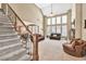 Bright living room with high ceilings, large windows, and a cozy fireplace at 5848 Deer Crossing Dr, Sugar Hill, GA 30518