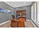 Comfortable home office featuring a large desk, built-in shelves, and bright natural light at 5848 Deer Crossing Dr, Sugar Hill, GA 30518
