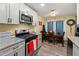 Modern kitchen featuring grey cabinets, granite countertops, and stainless steel appliances at 112 Silver Fox Trl, Dallas, GA 30157