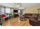 Cozy living room with hardwood floors, ceiling fan, and comfortable leather sectional at 112 Silver Fox Trl, Dallas, GA 30157