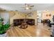 Inviting living room featuring hardwood floors, a ceiling fan and a comfortable brown leather sectional sofa at 112 Silver Fox Trl, Dallas, GA 30157