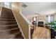 View of living room and staircase featuring a fireplace and comfortable seating at 112 Silver Fox Trl, Dallas, GA 30157