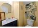 Charming powder room featuring blue vanity with a white sink and decorative wall art at 112 Silver Fox Trl, Dallas, GA 30157