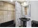 Cozy bathroom featuring a black sink, bathtub, modern fixtures, and decorative tile accent at 2285 Peachtree Ne Rd # 1207, Atlanta, GA 30309