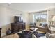 A well-lit living room with a comfortable sofa, large TV, and city view at 2285 Peachtree Ne Rd # 1207, Atlanta, GA 30309