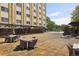 Inviting outdoor seating area with tables and chairs next to a beautiful building at 2285 Peachtree Ne Rd # 1207, Atlanta, GA 30309