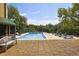 Community pool featuring lounge chairs and a peaceful wooded backdrop at 2285 Peachtree Ne Rd # 1207, Atlanta, GA 30309