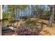 Spacious backyard with a patio, deck, and mature trees at 3270 River Summit Trl, Duluth, GA 30097