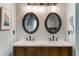 Well-lit bathroom features double vanity, wood cabinets, and modern lighting fixtures at 3270 River Summit Trl, Duluth, GA 30097
