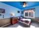 This bedroom with blue walls and ceiling, with a window that brings in plenty of sunlight at 3270 River Summit Trl, Duluth, GA 30097