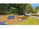 Stone entrance sign to The Summit at Riverbrooke with colorful flowers at 3270 River Summit Trl, Duluth, GA 30097