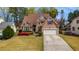 Charming two-story home with a well-maintained lawn and beautiful flowering bushes at 3270 River Summit Trl, Duluth, GA 30097
