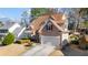 A well-manicured lawn complements this two-story house with an attached garage and a brown roof at 3270 River Summit Trl, Duluth, GA 30097